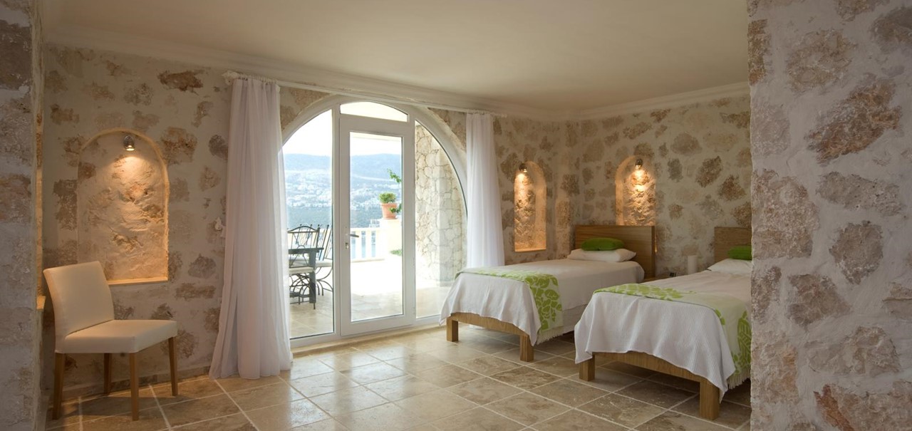 Large twin bedroom with door to dining terrace